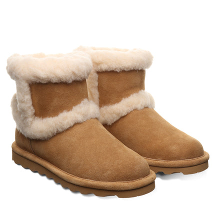 Close-up of BEARPAW Women's Kate Boot in Iced Coffee worn on foot, showing the boot as part of casual cold-weather styling.