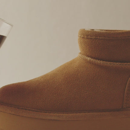 Bearpaw BearCoat water and stain repellent video demonstrating liquid beading off a treated Bearpaw shoe.